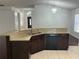 Kitchen bar with granite countertops, dual sink, and dark wood cabinetry at 8908 Southbay Dr, Tampa, FL 33615
