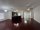 Open-concept living room with hardwood floors, stylish lighting, and sliding glass doors to a porch at 8908 Southbay Dr, Tampa, FL 33615