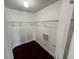 A spacious walk-in closet with wire shelving and dark laminate flooring offers ample storage solutions at 8908 Southbay Dr, Tampa, FL 33615