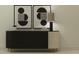 Stylish console table featuring mixed material doors, sleek hardware, and decor at 9328 Gladsome Dr, Land O Lakes, FL 34637