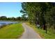 Picturesque lakeside path featuring a bench and tranquil views at 9328 Gladsome Dr, Land O Lakes, FL 34637
