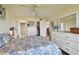 Light-filled bedroom has ceiling fan, wood floors, and closet, plus doors to bathroom and other rooms at 9450 Harbor Greens Way # 403, Seminole, FL 33776