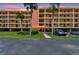 Beautiful condo complex featuring well-maintained landscaping and a view of the sunset at 9450 Harbor Greens Way # 403, Seminole, FL 33776