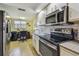Cozy kitchen with stainless appliances and adjacent workspace under a window at 9450 Harbor Greens Way # 403, Seminole, FL 33776