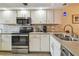 Efficient kitchen featuring stainless appliances, granite counters, and ample cabinet storage at 9450 Harbor Greens Way # 403, Seminole, FL 33776
