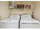 Laundry room with washer, dryer, and overhead storage shelf for convenience at 9450 Harbor Greens Way # 403, Seminole, FL 33776