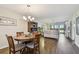 Open-concept living and dining area featuring hardwood floors and modern chandelier at 9450 Harbor Greens Way # 403, Seminole, FL 33776