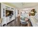 Spacious living room featuring hardwood floors, white sofa, and entertainment center at 9450 Harbor Greens Way # 403, Seminole, FL 33776