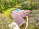 Aerial view of a home showing roof and landscaping and a pool at 10206 Lakeview Dr, New Port Richey, FL 34654