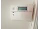 White ADT home security system mounted on wall, indicating armed and ready status for property protection at 10206 Lakeview Dr, New Port Richey, FL 34654