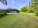 Spacious backyard featuring a screened-in pool area, ideal for relaxation and outdoor entertainment at 10206 Lakeview Dr, New Port Richey, FL 34654