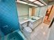 Bathroom featuring a dual sink vanity, blue fixtures and tile flooring at 10206 Lakeview Dr, New Port Richey, FL 34654