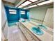 Bathroom featuring a dual sink vanity and blue fixtures at 10206 Lakeview Dr, New Port Richey, FL 34654