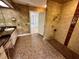 Bathroom featuring a tiled shower, vanity with sink, unique tile flooring, and an open doorway at 10206 Lakeview Dr, New Port Richey, FL 34654