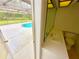 Poolside bathroom with modern sink, toilet, and access to the screened-in outdoor area at 10206 Lakeview Dr, New Port Richey, FL 34654