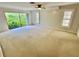 Bright bedroom features a ceiling fan and sliding doors to the backyard at 10206 Lakeview Dr, New Port Richey, FL 34654