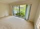 Bedroom with a sliding glass door overlooking lush tropical landscaping and a pool at 10206 Lakeview Dr, New Port Richey, FL 34654