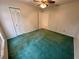 Bedroom featuring green carpet, ceiling fan and double door closet at 10206 Lakeview Dr, New Port Richey, FL 34654
