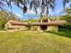 Charming single-story home with a well-maintained lawn, mature trees, and inviting landscaping at 10206 Lakeview Dr, New Port Richey, FL 34654