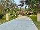 Attractive single-story home featuring lush landscaping, a long driveway, and inviting curb appeal at 10206 Lakeview Dr, New Port Richey, FL 34654