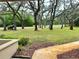 Lush front yard with mature trees, beautiful landscaping, and a view of the quiet street at 10206 Lakeview Dr, New Port Richey, FL 34654