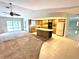 The kitchen overlooks the living room and features wood cabinets, tile floors, and a center island with a wine rack at 10206 Lakeview Dr, New Port Richey, FL 34654