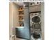 Compact laundry area with modern washer/dryer, sleek cabinets, and stylish tile backsplash at 10206 Lakeview Dr, New Port Richey, FL 34654