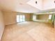 Spacious living room features floor-to-ceiling mirrors and sliding doors to the pool at 10206 Lakeview Dr, New Port Richey, FL 34654