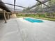 A serene screened-in pool offers a private oasis for relaxation and enjoyment with green surroundings at 10206 Lakeview Dr, New Port Richey, FL 34654