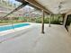 Enjoy the screened-in pool and large patio with ceiling fans, perfect for outdoor relaxation and entertainment at 10206 Lakeview Dr, New Port Richey, FL 34654