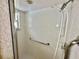 Tiled shower with grab bar and shower seat at 10206 Lakeview Dr, New Port Richey, FL 34654