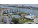 Aerial view of a condo complex with tennis courts, a pool and waterfront views at 10215 Regal Dr # 21, Largo, FL 33774