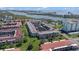 Aerial view of a condo complex located on the water with a pool and well-kept grounds at 10215 Regal Dr # 21, Largo, FL 33774