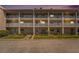 Exterior view of a three-story condo building with white railings and well-maintained landscaping at 10215 Regal Dr # 21, Largo, FL 33774