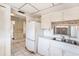 Vintage kitchen features white cabinets, laminate countertops, and dated appliances at 10215 Regal Dr # 21, Largo, FL 33774