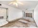 View of a dated living room featuring mirrored wall and sliding doors to balcony at 10215 Regal Dr # 21, Largo, FL 33774