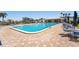 Rectangular community pool with surrounding brick pavers and lounge chairs at 10215 Regal Dr # 21, Largo, FL 33774