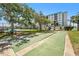 Two shuffleboard courts with seating and a view of the condo building at 10215 Regal Dr # 21, Largo, FL 33774