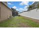 Expansive backyard with well-maintained lawn, privacy fence and screened-in pool at 10322 Riverburn Dr, Tampa, FL 33647