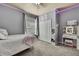 Cozy bedroom featuring gray walls, carpeted floor, window and closet at 10322 Riverburn Dr, Tampa, FL 33647