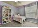 Cozy bedroom featuring gray walls, carpeted floor, window and shelving at 10322 Riverburn Dr, Tampa, FL 33647