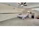 Bedroom area with neutral-toned walls, a ceiling fan and a desk at 10322 Riverburn Dr, Tampa, FL 33647