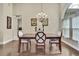 Formal dining room featuring wood floors, high ceilings, and elegant chandelier at 10322 Riverburn Dr, Tampa, FL 33647