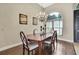Dining room with hardwood floors, a chandelier, and large windows at 10322 Riverburn Dr, Tampa, FL 33647