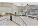Bright open concept kitchen overlooking the pool with white cabinets and stainless appliances at 10322 Riverburn Dr, Tampa, FL 33647
