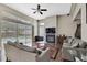 Bright living room with large sliding doors leading to the pool area, a fireplace, and hardwood floors at 10322 Riverburn Dr, Tampa, FL 33647