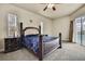 Main bedroom featuring a king bed, carpet, a ceiling fan, and sliding glass doors to the pool at 10322 Riverburn Dr, Tampa, FL 33647