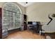 Charming office space featuring a large window, hardwood floors, and an entertainment area at 10322 Riverburn Dr, Tampa, FL 33647