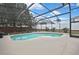 Sparkling pool inside a screened lanai surrounded by lush greenery and a privacy fence at 10322 Riverburn Dr, Tampa, FL 33647