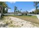 Expansive backyard with grass and a privacy fence surrounds the home's exterior at 106 Ne 1St Ave, Lutz, FL 33549
